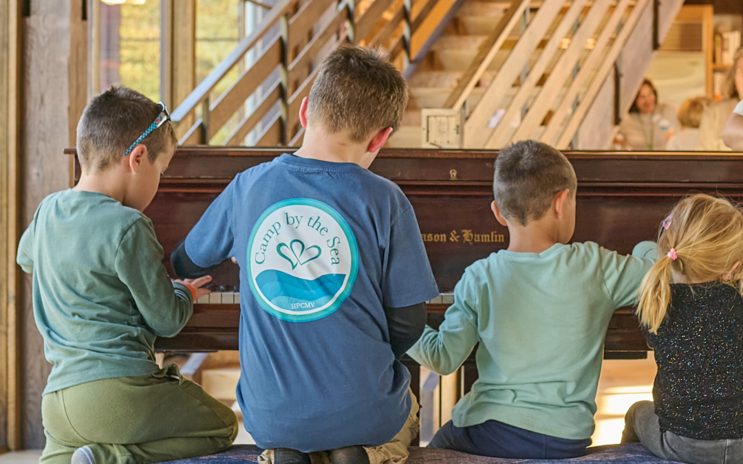 kids at camp by the sea playing the piano at slough farm