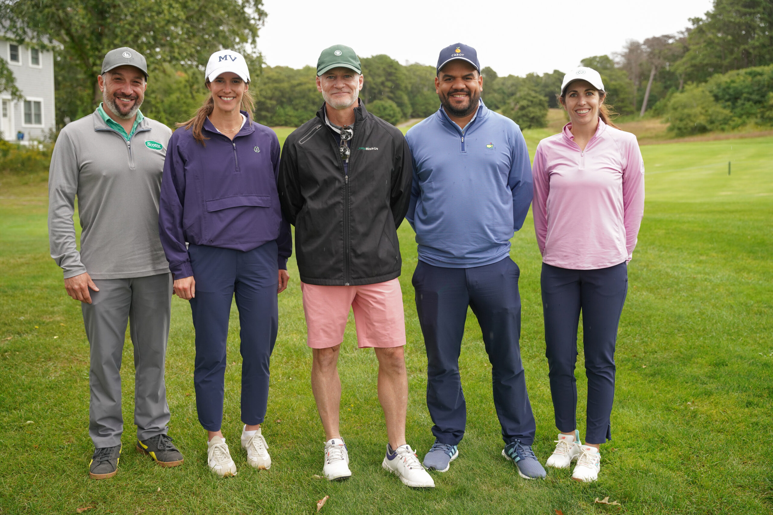 Scotts Miracle Gro golf team standing on the green 