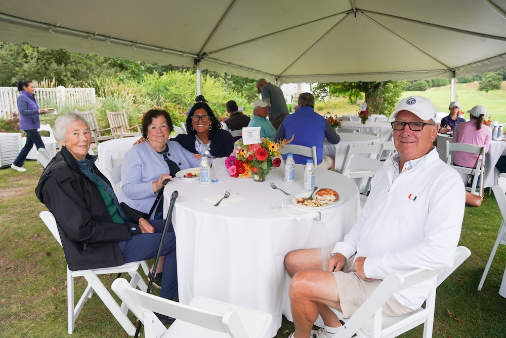 Polly Brown and Sue Lamoreaux's table under the tent at the golf luncheon 